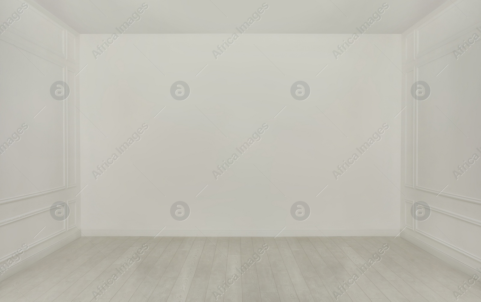 Photo of Empty room with white walls and laminated flooring