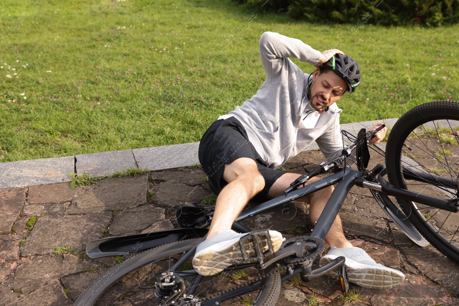 Photo of Man fallen off his bicycle in park