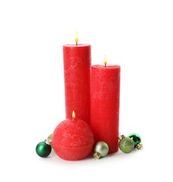 Photo of Beautiful burning candles with Christmas decor on white background