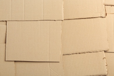 Photo of Pieces of cardboard as background, top view. Recycling concept