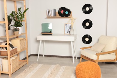Photo of Room interior with stylish turntable on white table and vinyl records