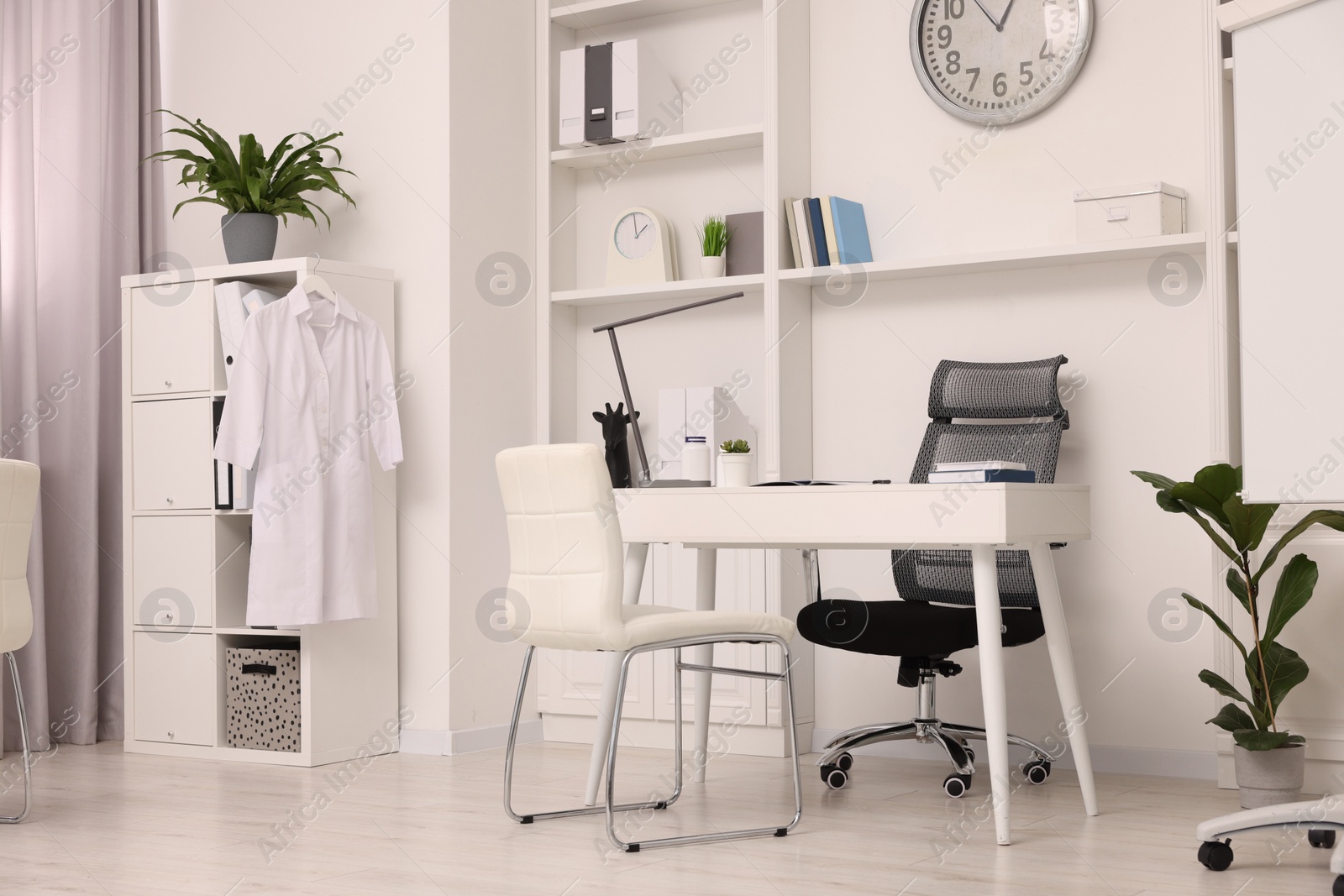 Photo of Modern medical office interior with doctor's workplace