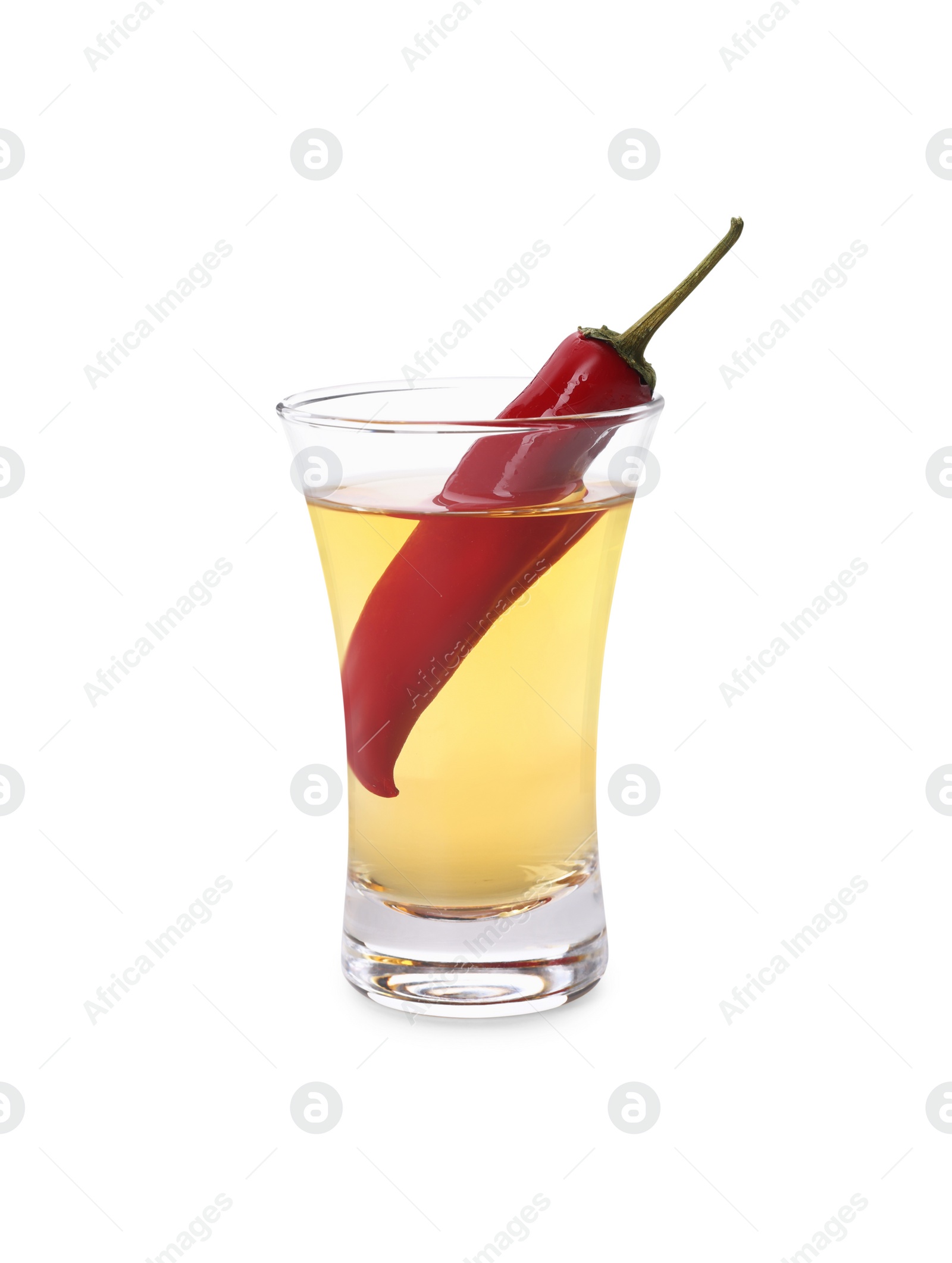 Photo of Red hot chili pepper and vodka in shot glass on white background