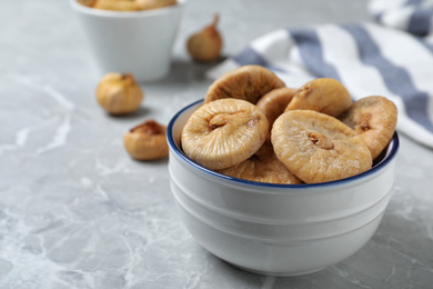 Photo of Tasty dried figs on light grey marble table, closeup