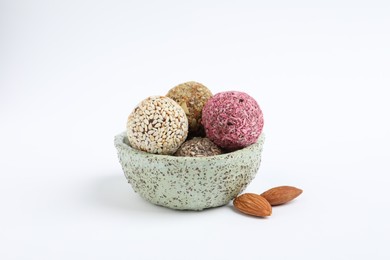 Different delicious vegan candy balls and almonds on white background