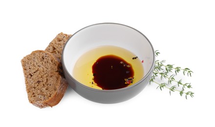 Photo of Bowl of organic balsamic vinegar with oil, spices and bread isolated on white