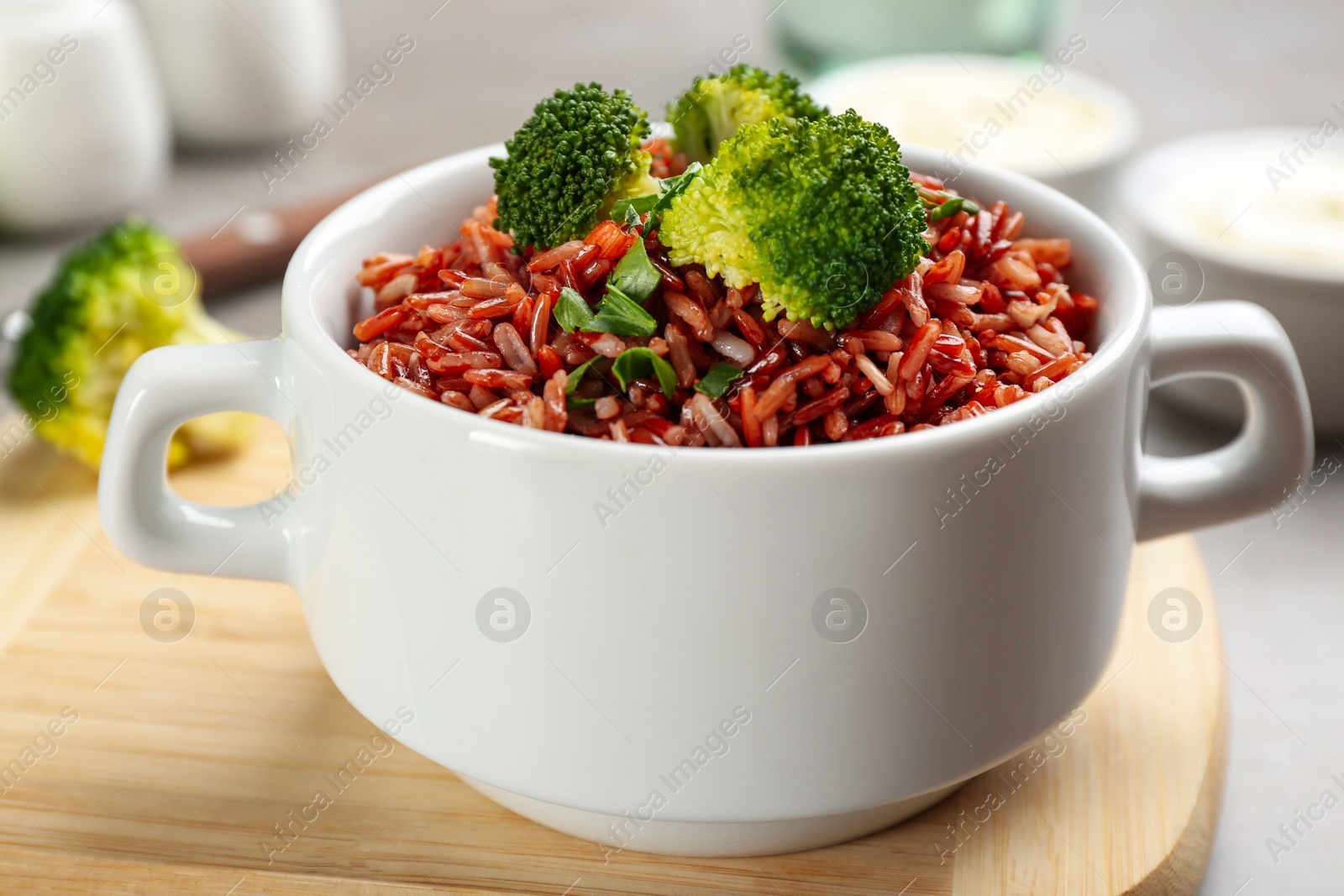 Photo of Tasty brown rice with broccoli on table, closeup