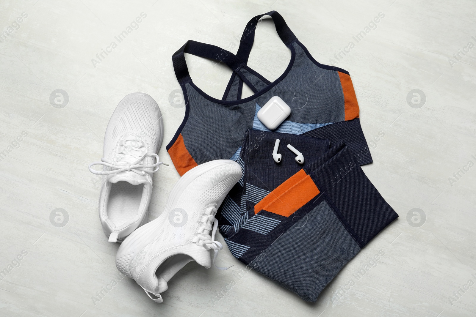 Photo of Flat lay composition with stylish sport shoes on light background