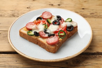 Photo of Tasty pizza toast on wooden table, closeup