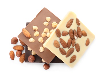 Different delicious chocolate bars with nuts on white background