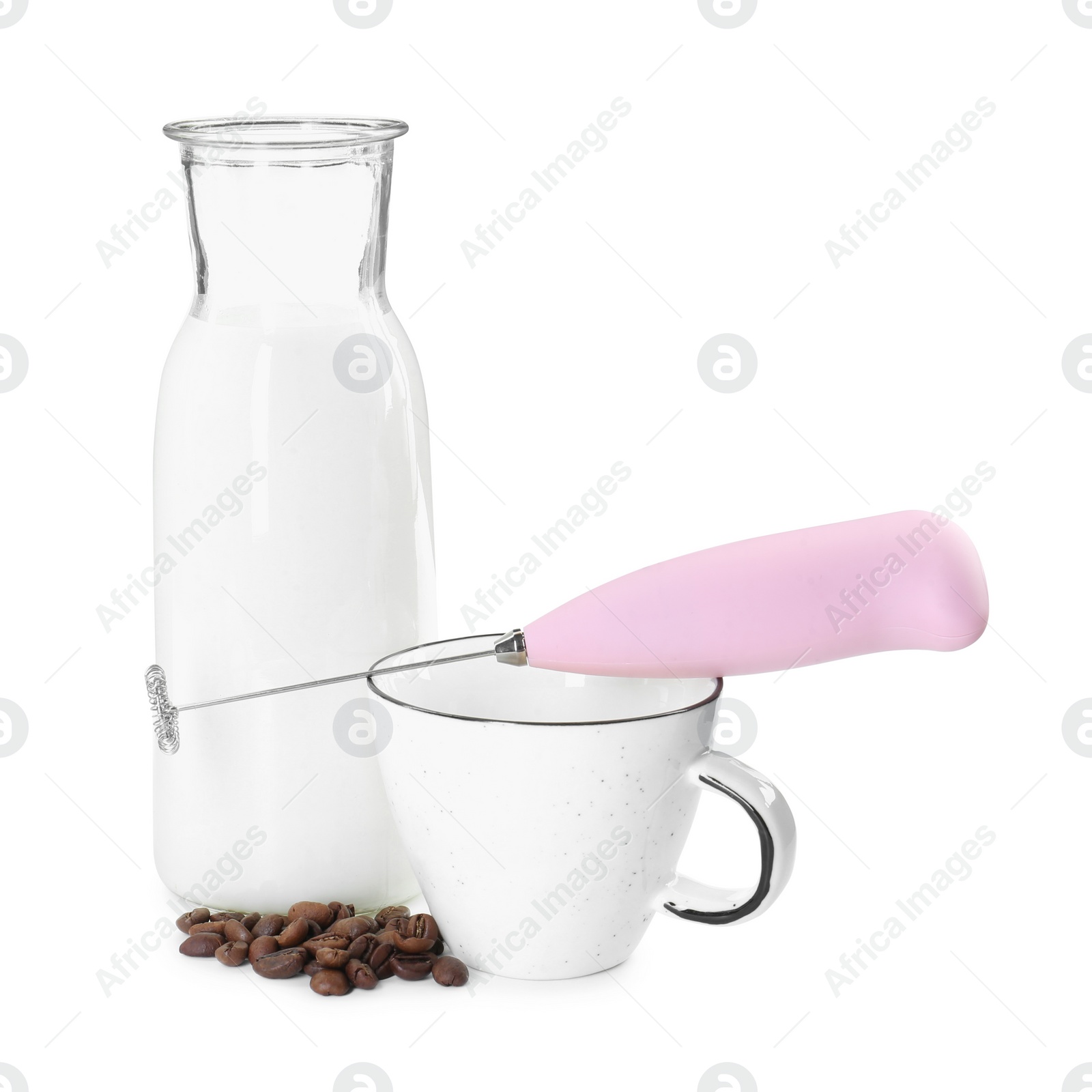 Photo of Pink mini mixer (milk frother), cup, coffee beans and bottle isolated on white