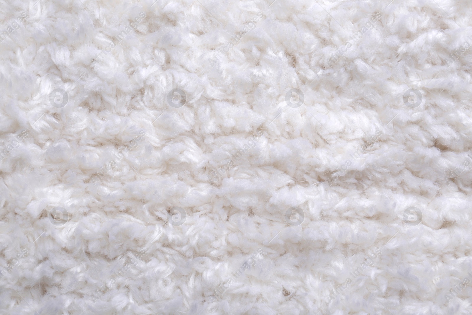 Photo of Soft white knitted fabric as background, top view