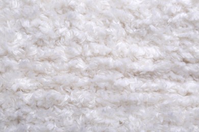 Photo of Soft white knitted fabric as background, top view