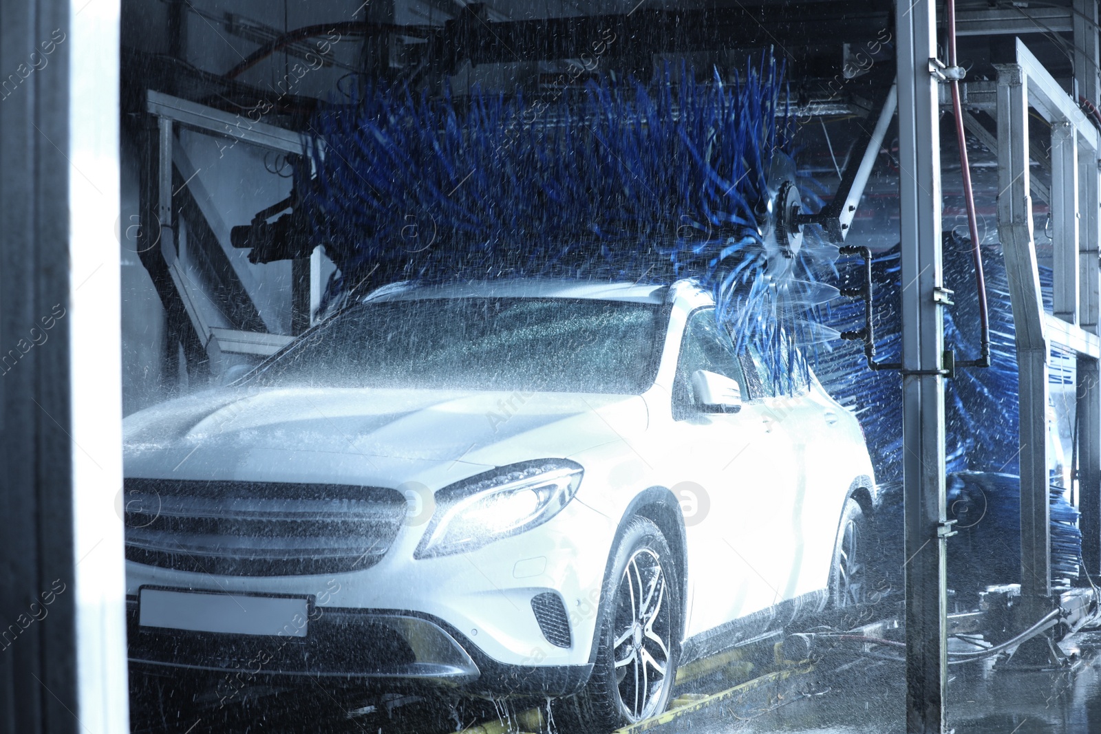 Photo of Modern auto undergoing cleaning at car wash