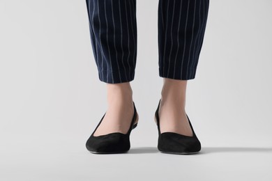 Photo of Businesswoman in black shoes on white background, closeup