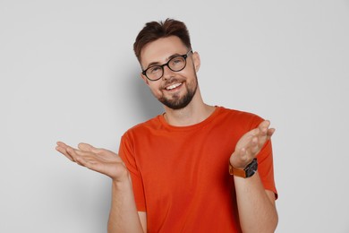 Photo of Handsome man in eyeglasses on light grey background