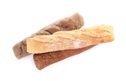 Photo of Different tasty baguettes on white background, top view. Fresh bread