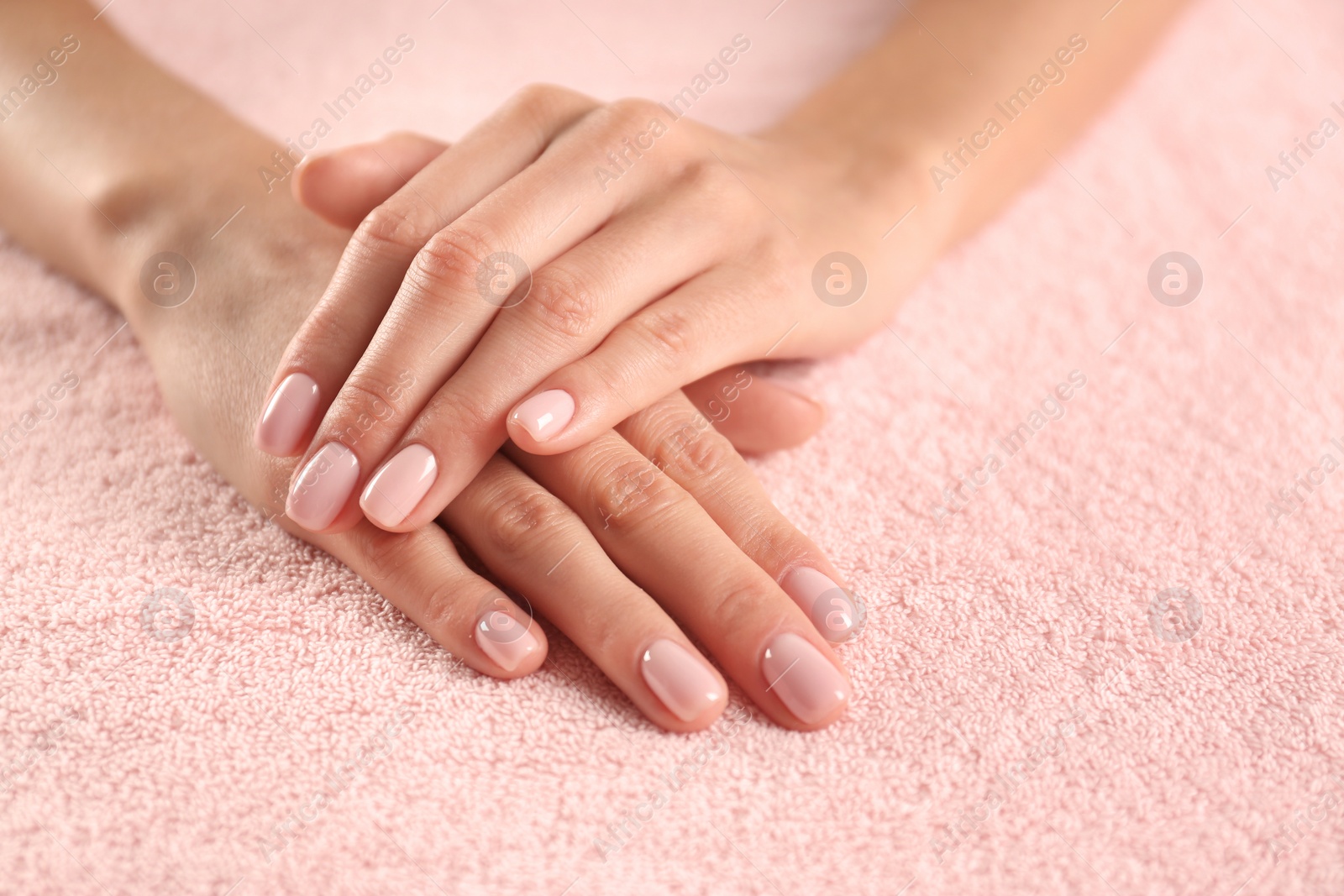 Photo of Closeup view of beautiful female hands on towel, space for text. Spa treatment