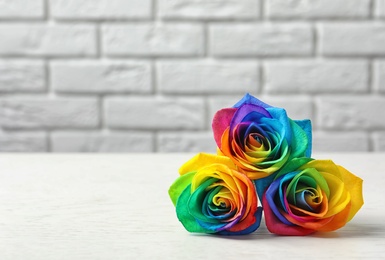 Amazing rainbow rose flowers on table