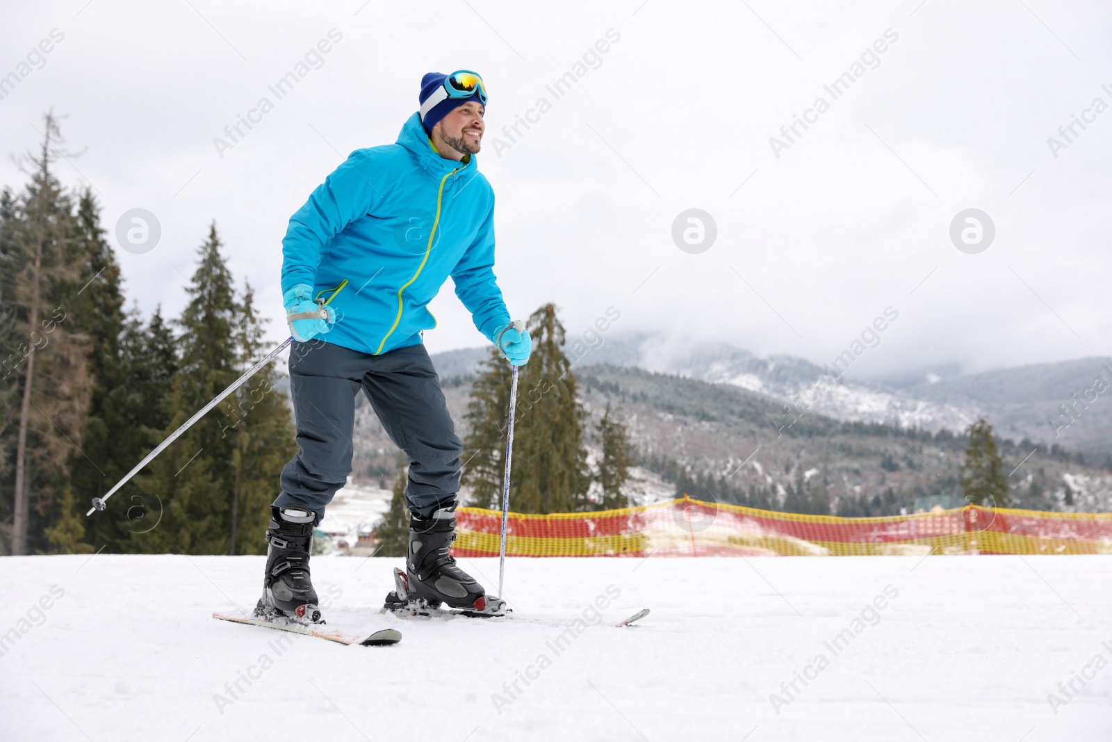 Photo of Male skier on slope at resort, space for text. Winter vacation