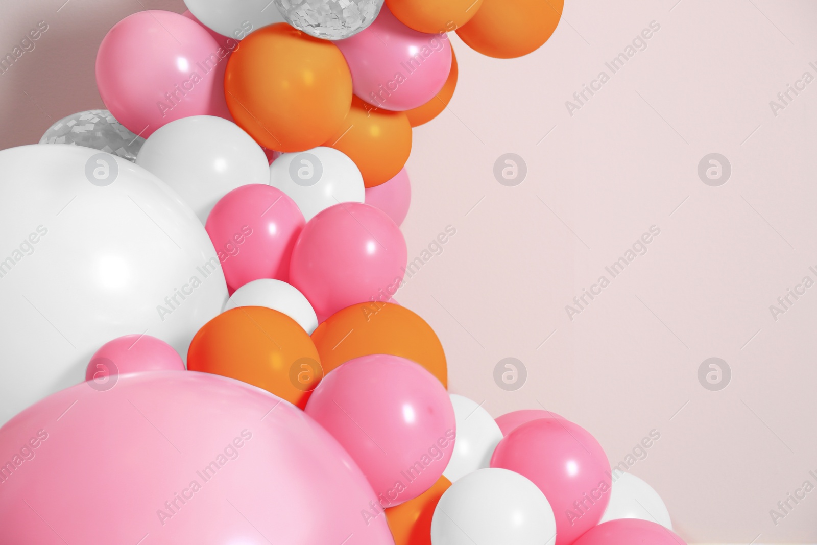 Image of Balloon garland on beige background. Festive decor