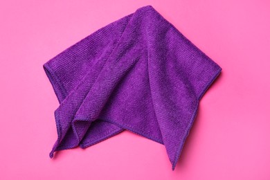 Purple microfiber  cloth on pink background, top view