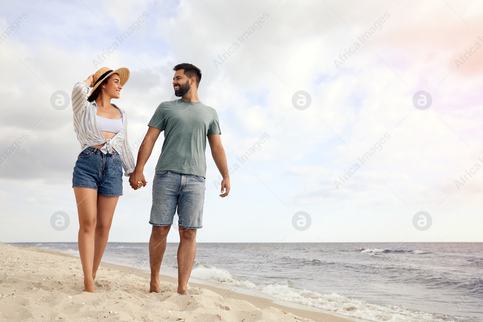 Photo of Lovely couple spending time together on beach