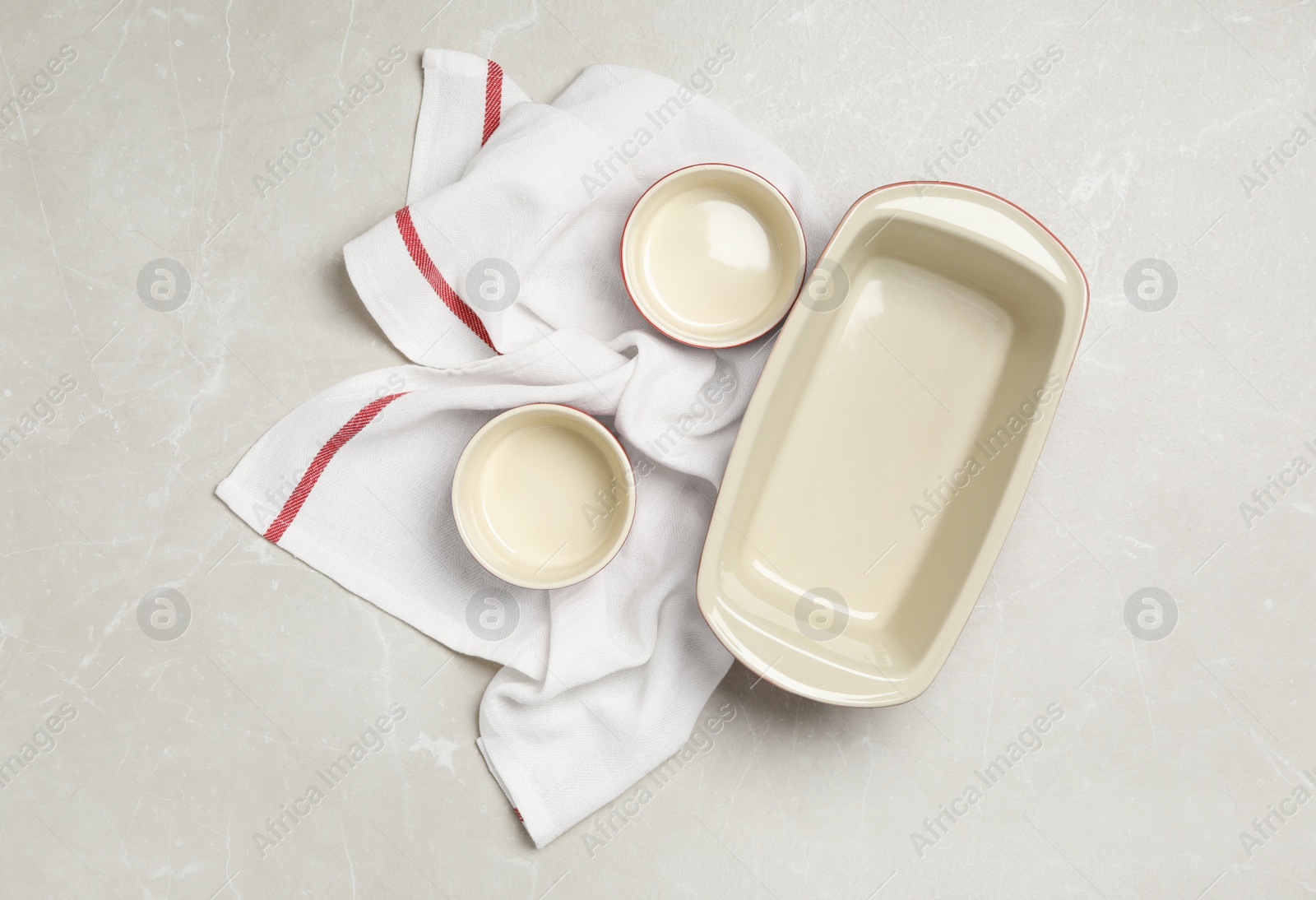 Photo of Baking dishes on grey table, flat lay. Cooking utensils