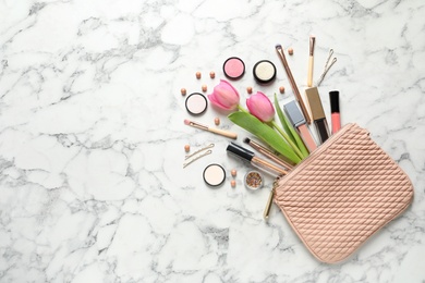 Photo of Many different makeup products and spring flowers on marble background, flat lay. Space for text