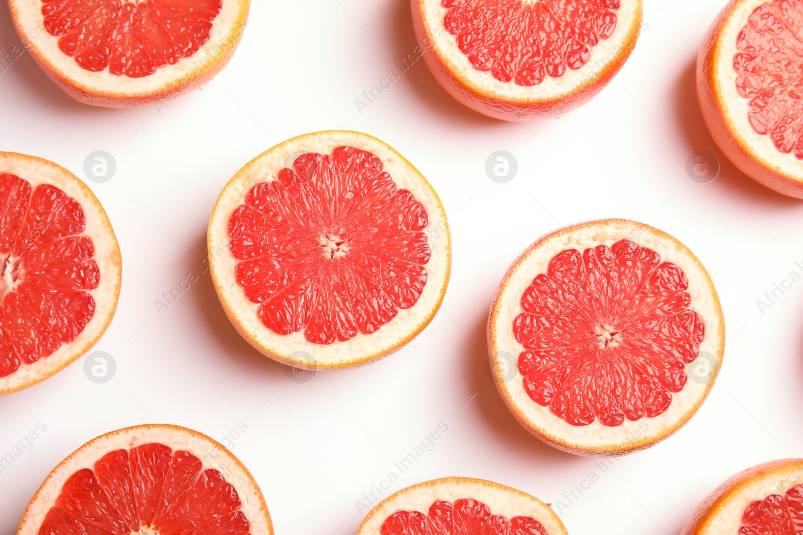 Photo of Fresh sliced ripe grapefruits on white background, top view