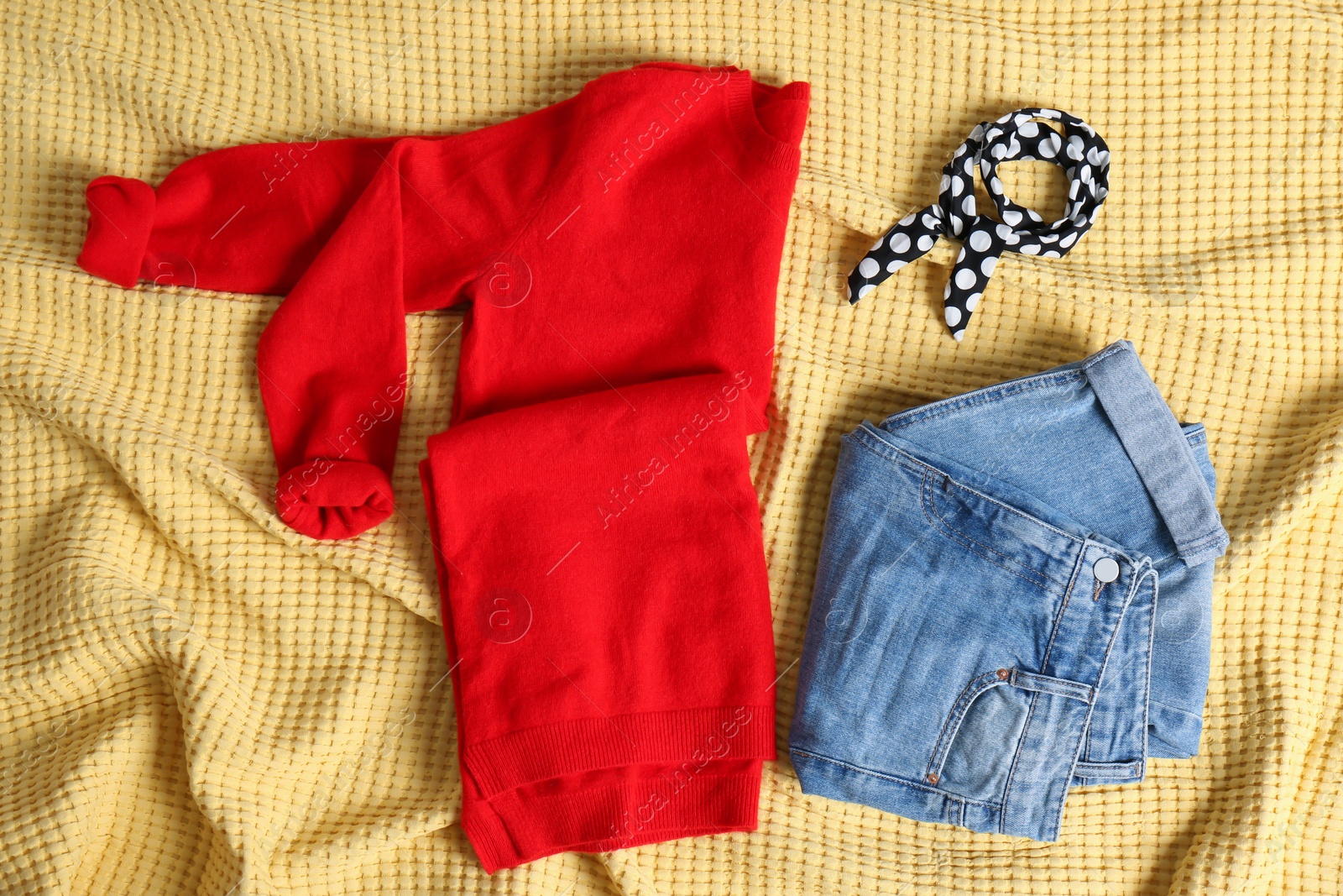 Photo of Flat lay composition with cashmere sweater and jeans on soft plaid