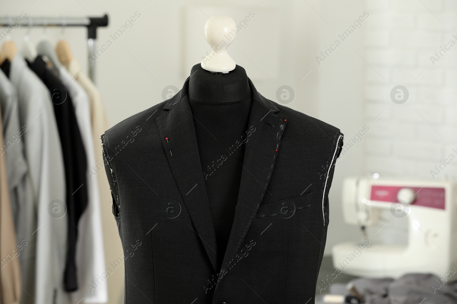 Photo of Mannequin with unfinished jacket in tailor shop