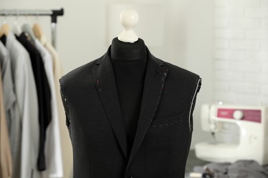 Mannequin with unfinished jacket in tailor shop