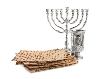 Photo of Traditional matzos, wine and menorah on white background