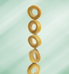 Image of Stacked slices of olive on light green gradient background