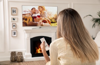 Image of Woman watching romantic movie on TV at home