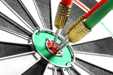 Dart board with color arrows hitting target, closeup