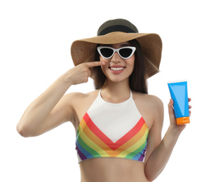Young woman with sun protection cream on white background