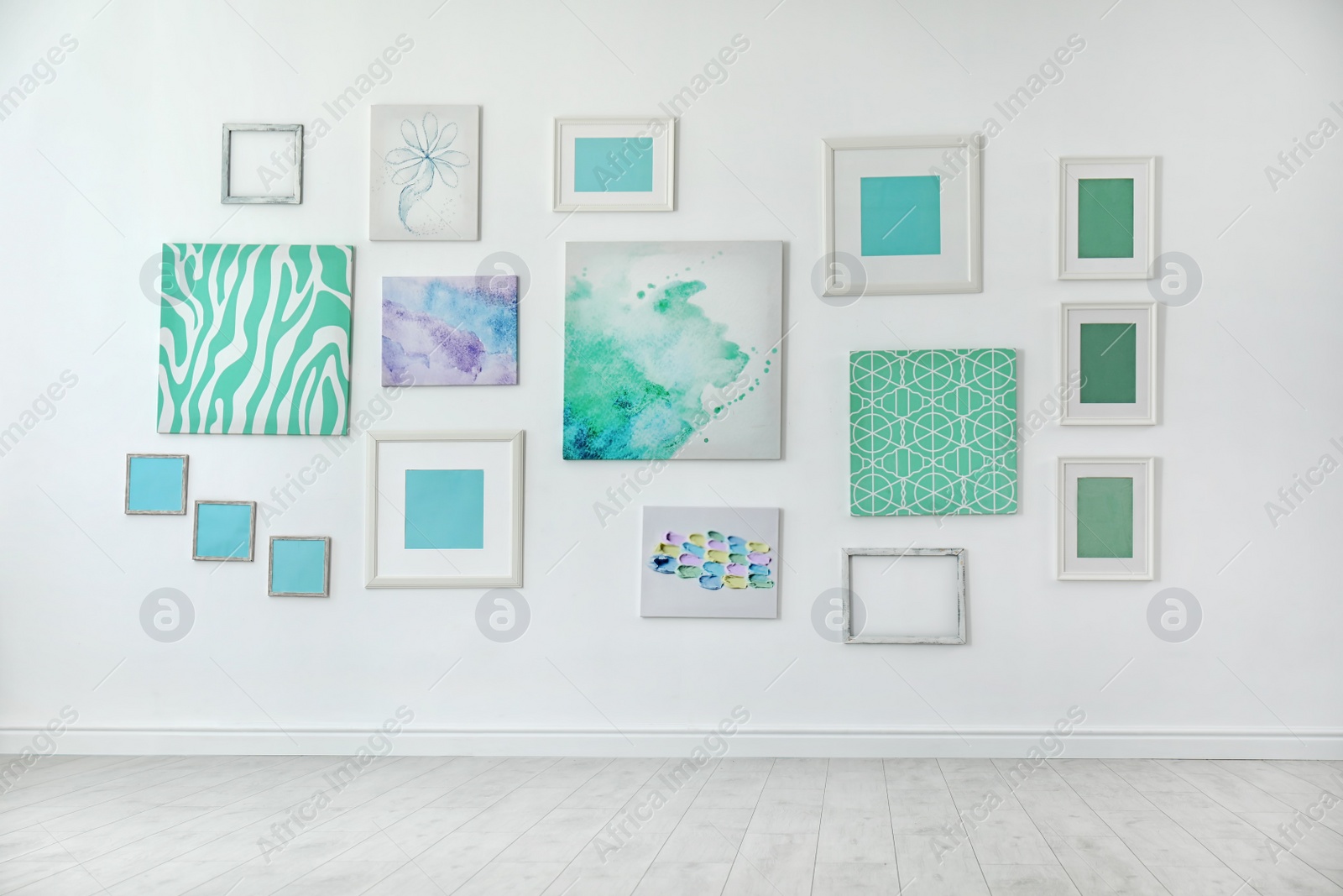 Photo of Many abstract mint paintings on light wall