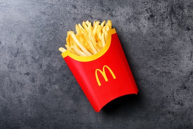MYKOLAIV, UKRAINE - AUGUST 12, 2021: Big portion of McDonald's French fries on grey table, top view