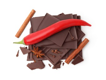 Photo of Red hot chili pepper and pieces of dark chocolate with spices isolated on white, top view