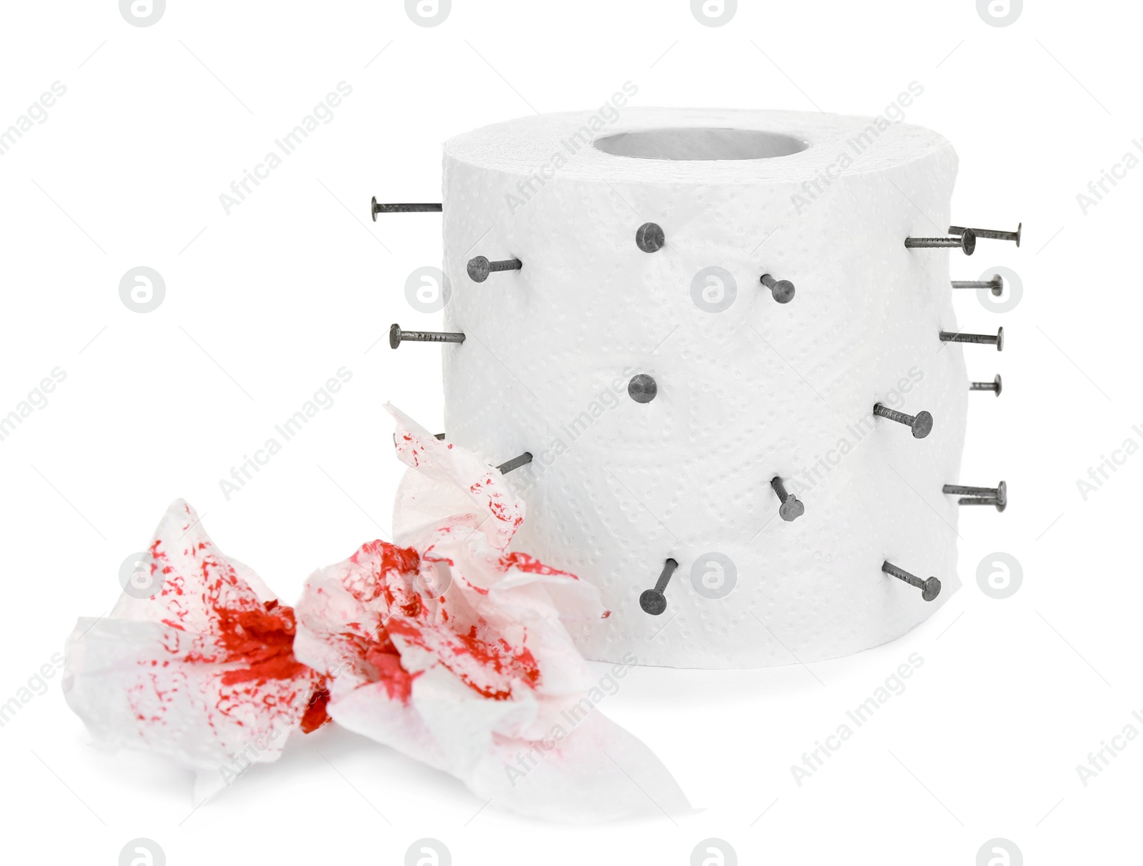 Photo of Roll of toilet paper with nails on white background. Hemorrhoid problems