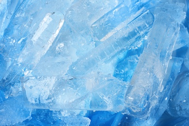 Many pieces of ice on color background