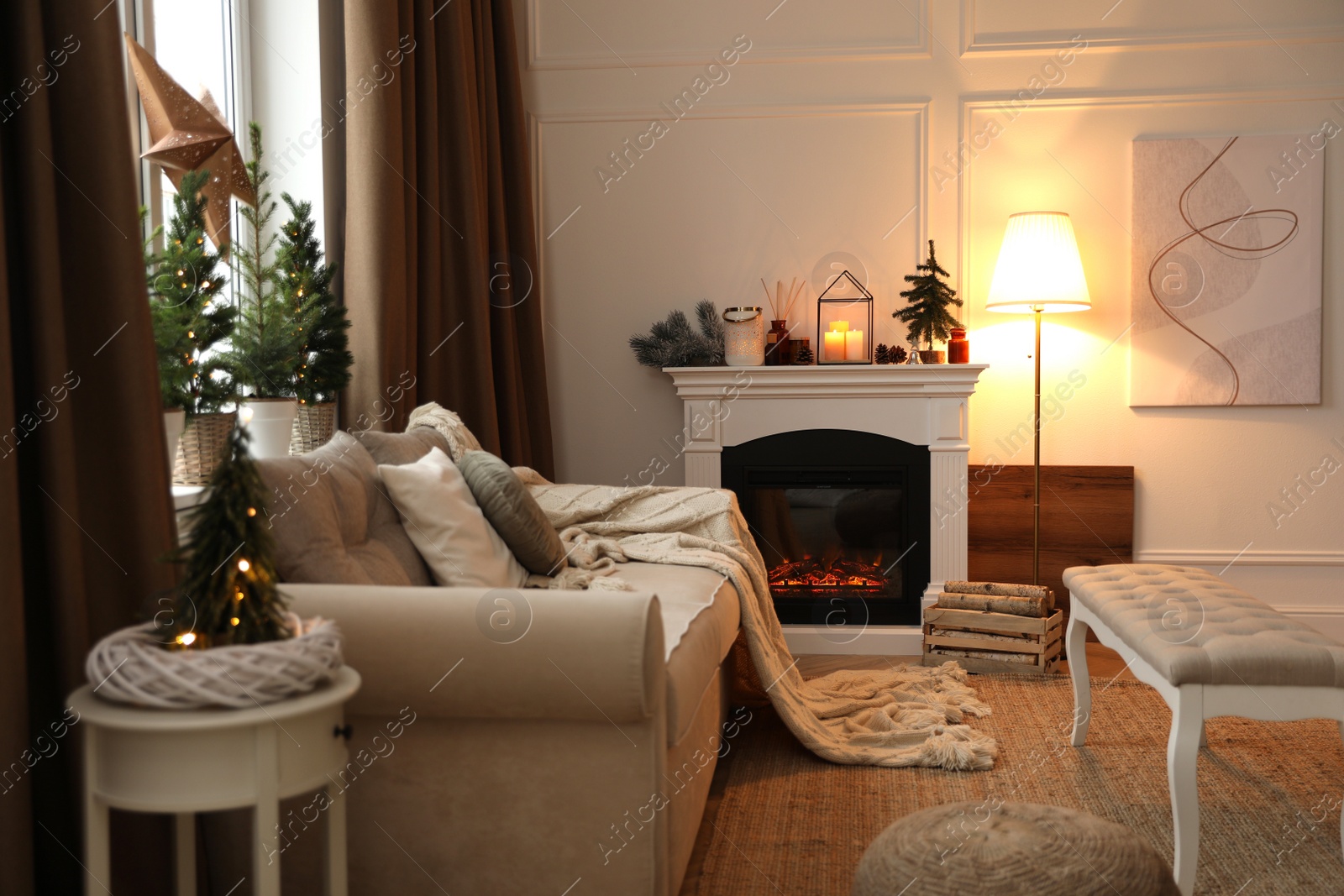 Photo of Fireplace in room with Christmas decorations. Interior design