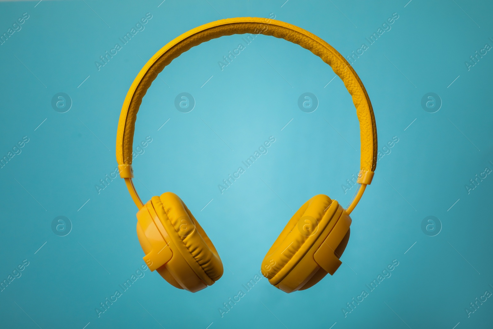 Photo of Wireless headphones with earmuffs on color background