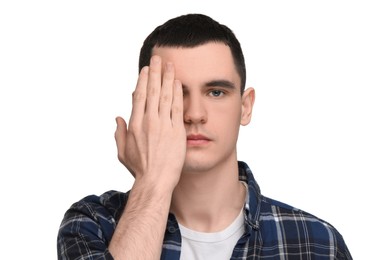 Young man covering his eye on white background