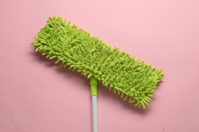 Mop with plastic handle on pink background, top view