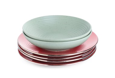 Photo of Stack of beautiful ceramic plates and bowls isolated on white