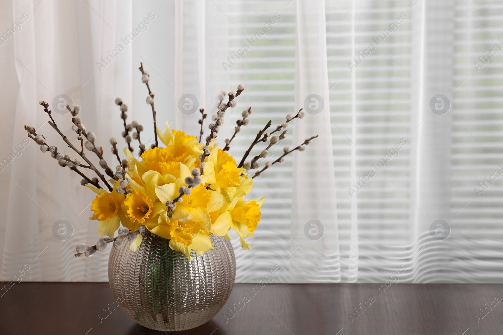Photo of Bouquet of beautiful yellow daffodils in vase on table. Space for text