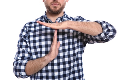 Photo of Man showing TIME OUT gesture in sign language on white background, closeup